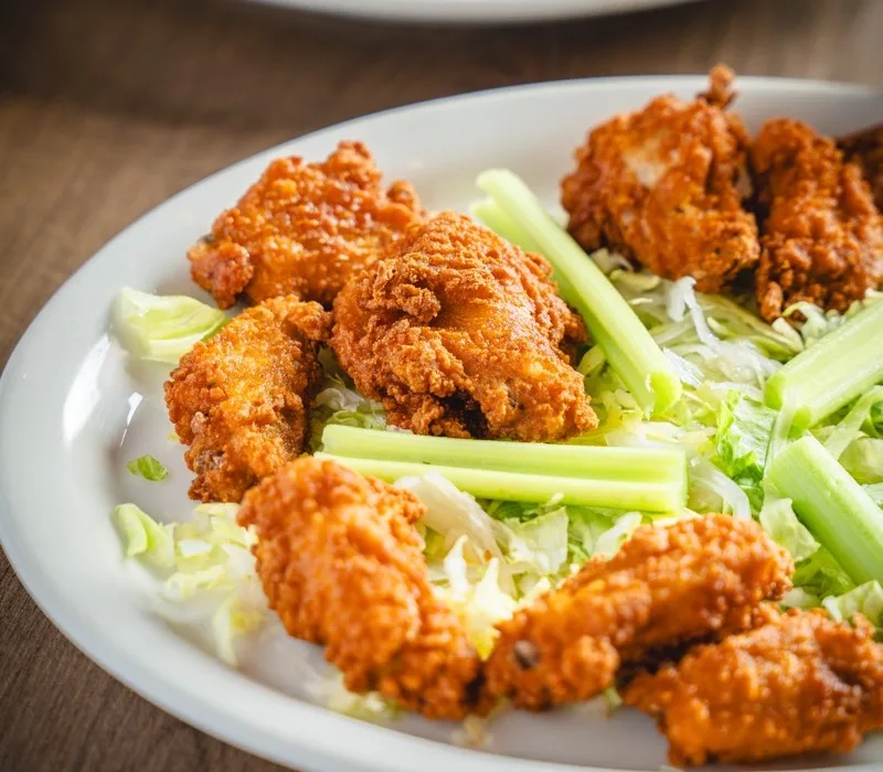 Crispy chicken wings served with celery