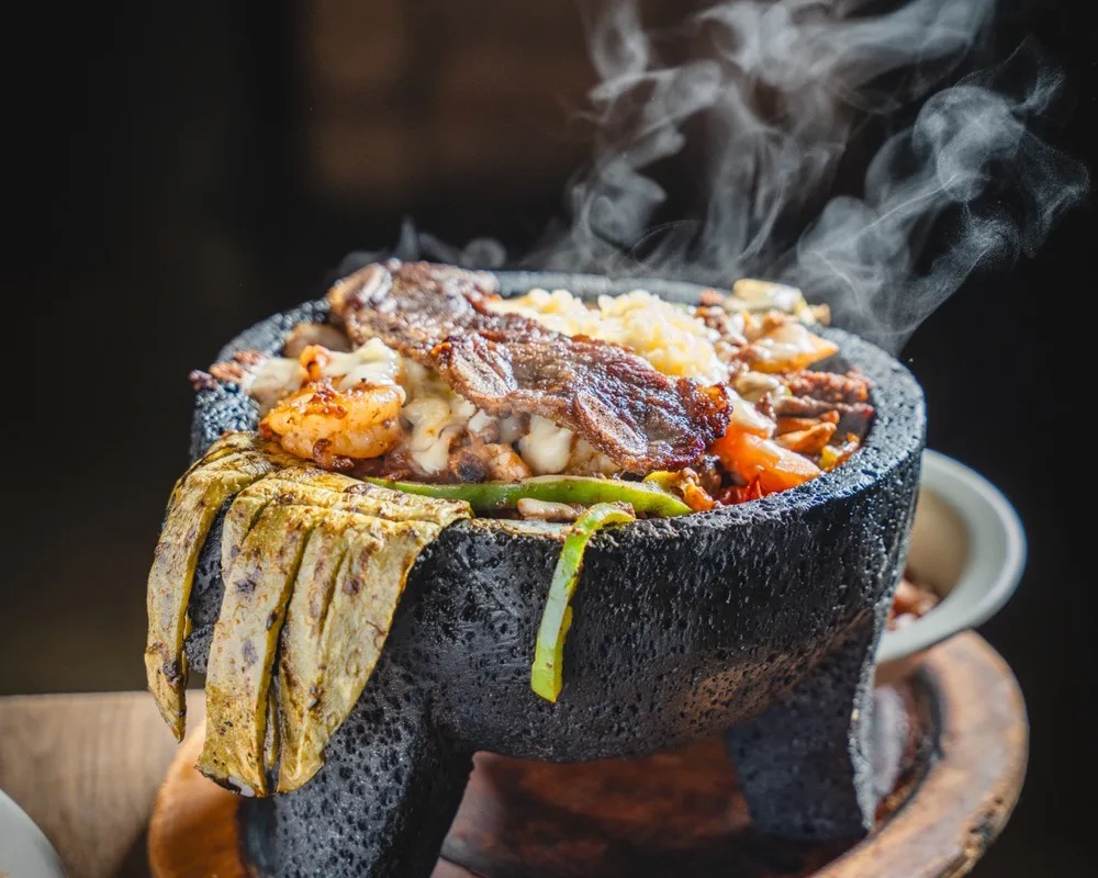 Molcajete especial with steak, chicken and shrimp over cactus