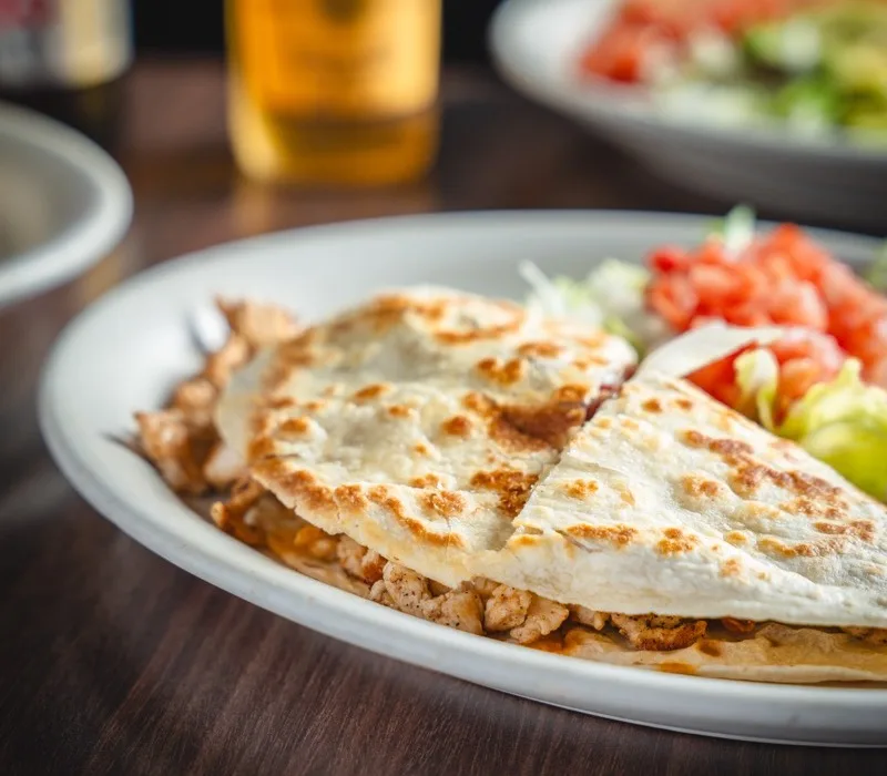 Quesadillas locas stuffed with grilled meat and melted cheese